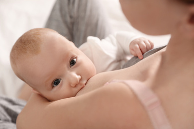 Young woman breast feeding her little baby, above view