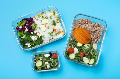 Set of glass containers with fresh food on light blue background, flat lay