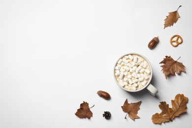 Flat lay composition with hot cozy drink and autumn leaves on white background. Space for text
