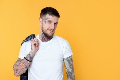 Photo of Portrait of handsome hipster man on yellow background. Space for text