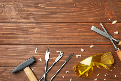 Flat lay composition with carpenter's tools on wooden background. Space for text
