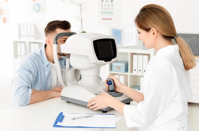 Ophthalmologist examining patient in clinic