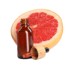 Bottle of citrus essential oil, pipette and fresh grapefruit on white background