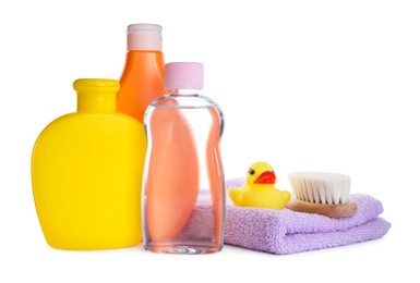 Baby oil, toiletries and toy duck on white background