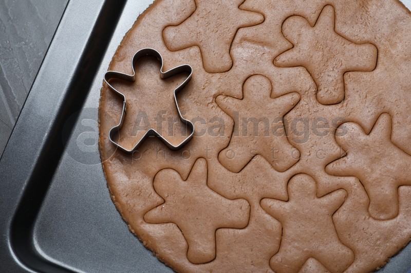 Making homemade gingerbread man cookies in baking dish , top view