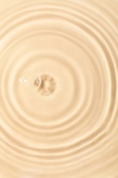 Closeup view of water with rippled surface on beige background