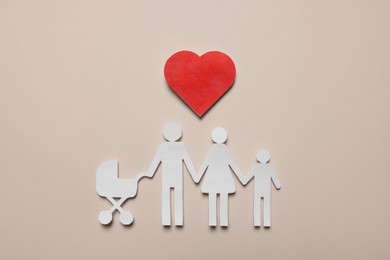 Paper family figures and red heart on beige background, flat lay. Insurance concept