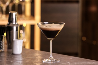 Glass of delicious Espresso Martini on bar counter. Alcohol cocktail