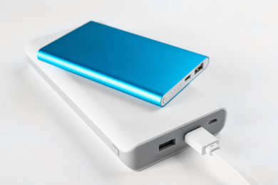 Modern external portable chargers on white 
 background