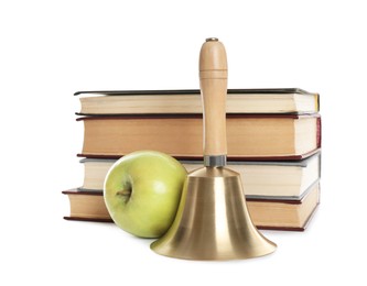 Golden school bell with wooden handle, apple and stack of books on white background