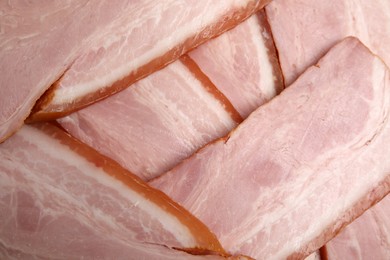 Slices of delicious smoked bacon as background, closeup