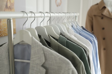 Collection of stylish woman's clothes in modern boutique, closeup