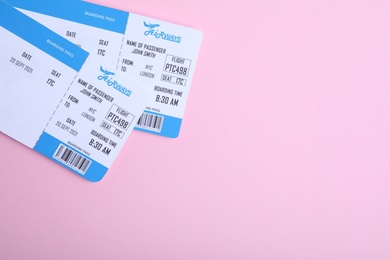Tickets on pink background, flat lay with space for text. Travel agency concept