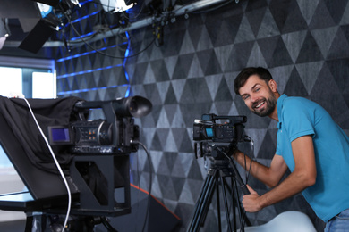 Professional video camera operator working in studio
