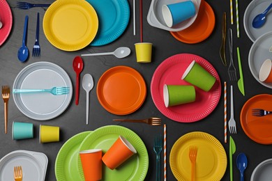 Photo of Flat lay composition with different disposable tableware on black background