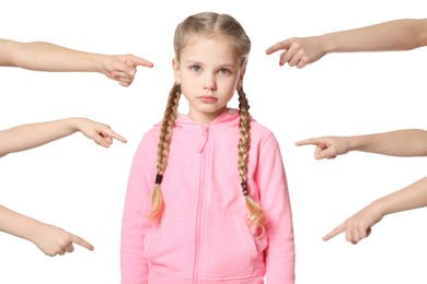 Photo of Kids pointing at upset girl on white background. Children's bullying