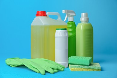 Cleaning supplies and tools on light blue background