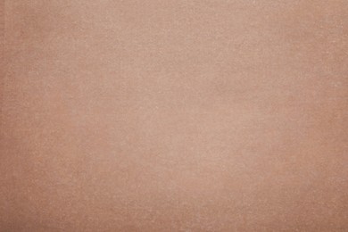 Texture of brown baking paper as background, top view