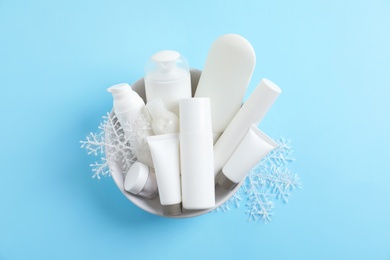 Set of cosmetic products on blue background, top view. Winter care