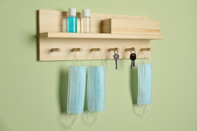 Wooden hanger for keys on light green wall