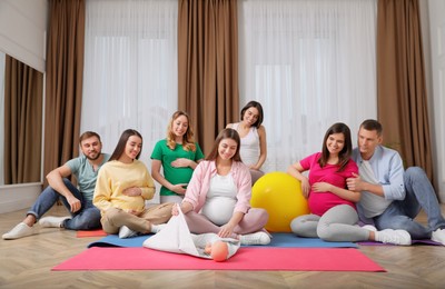 Group of pregnant women and men at courses for expectant parents