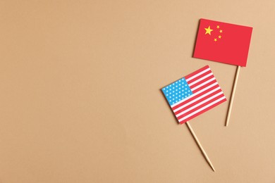 American and Chinese flags in beige background, top view with space for text. Trade war