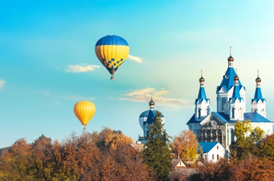 KAMIANETS-PODILSKYI, UKRAINE - OCTOBER 06, 2018: Beautiful view of hot air balloons flying near Saint George's Cathedral