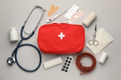 Flat lay composition with first aid kit on light grey background