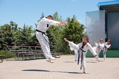 OCHAKIV, UKRAINE - JULY 09, 2020: Girl practicing karate with coach in summer camp "Sportium"