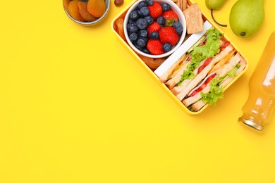 Flat lay composition with lunch box, tasty healthy food and juice on yellow background, space for text. School dinner