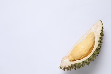 Piece of fresh ripe durian on white background, top view. Space for text