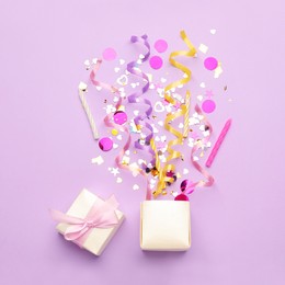 Beautiful flat lay composition with gift box and festive items on violet background. Surprise party concept