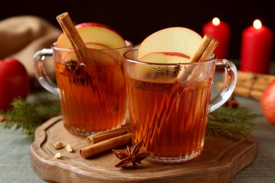 Aromatic hot mulled cider on wooden board