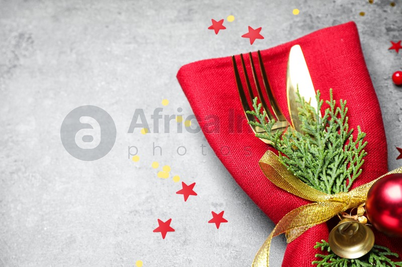 Cutlery set on grey table, closeup with space for text. Christmas celebration