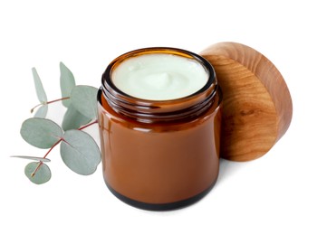 Jar of hand cream and eucalyptus on white background