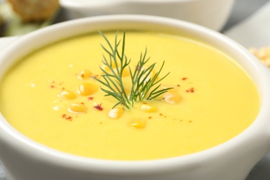 Delicious creamy corn soup in bowl, closeup