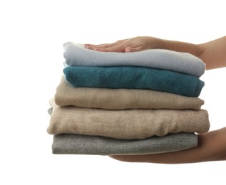 Photo of Woman with folded cashmere clothes on white background, closeup