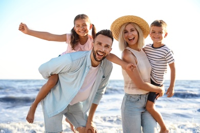 Happy family on beach near sea. Summer vacation