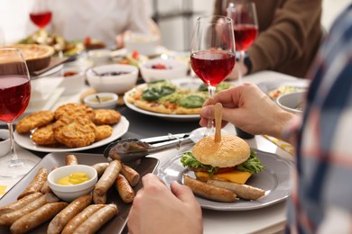 Photo of People having brunch together at table indoors, closeup