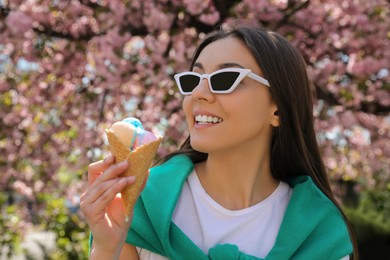 Photo of Young woman with icecream in beautiful park