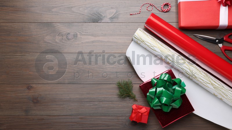 Flat lay composition with beautifully wrapped gift boxes on wooden table, space for text