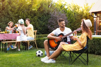 Photo of Group of young friends at barbecue party outdoors