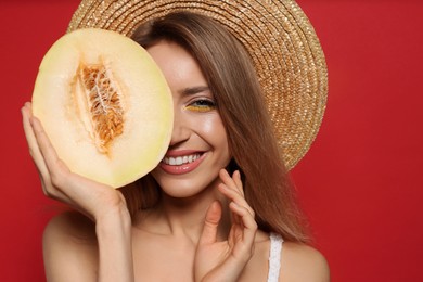 Photo of Young woman with fresh melon on red background. Exotic fruit