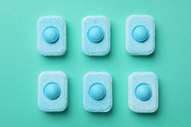 Photo of Water softener tablets on turquoise background, flat lay