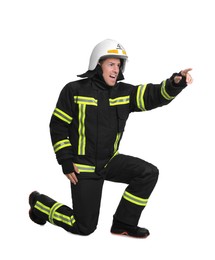 Full length portrait of firefighter in uniform and helmet on white background