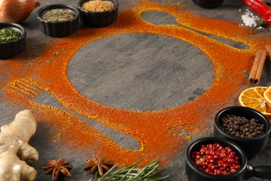 Photo of Beautiful composition with different spices, silhouettes of cutlery and plate on grey table, closeup