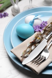 Festive Easter table setting with eggs on white background, closeup