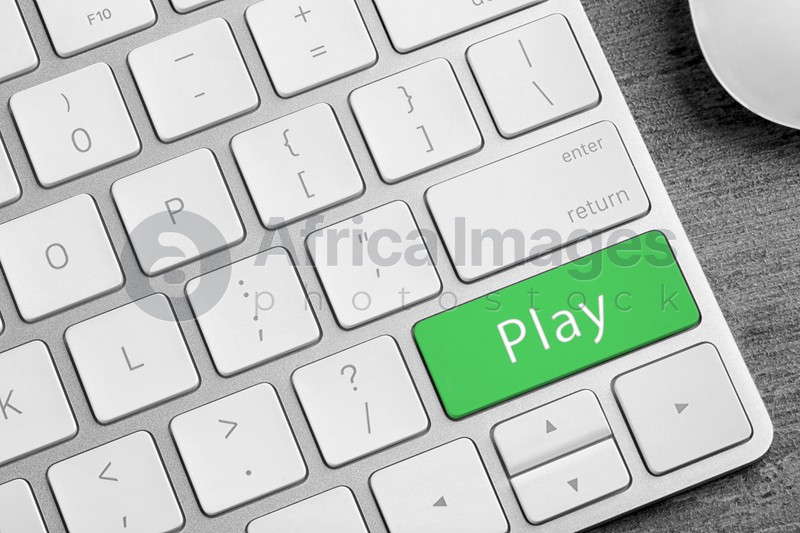 Computer keyboard with button Play on table, closeup. Online games concept