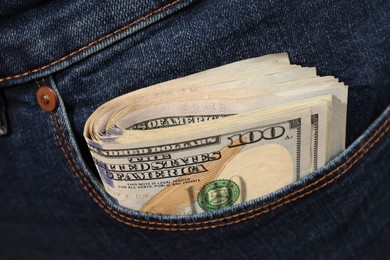 Dollar banknotes in pocket of jeans, closeup. Spending money