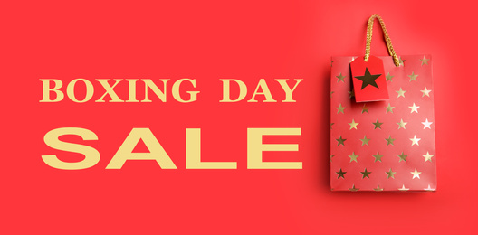 Boxing day sale. Shopping bag on red background, banner design